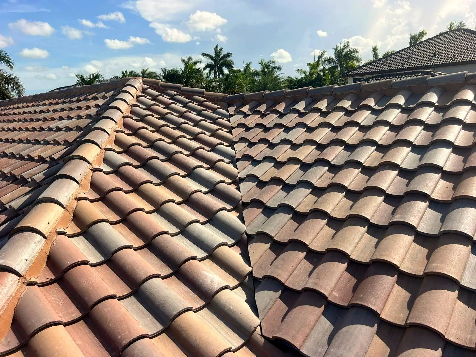 Clay barrel tile courses meeting at a roof valley