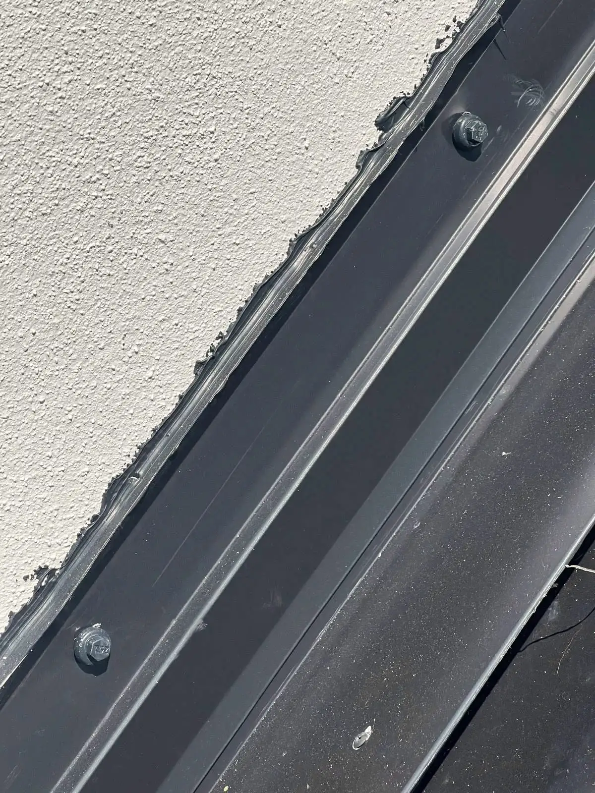 Metal flashing sealed against a stucco wall