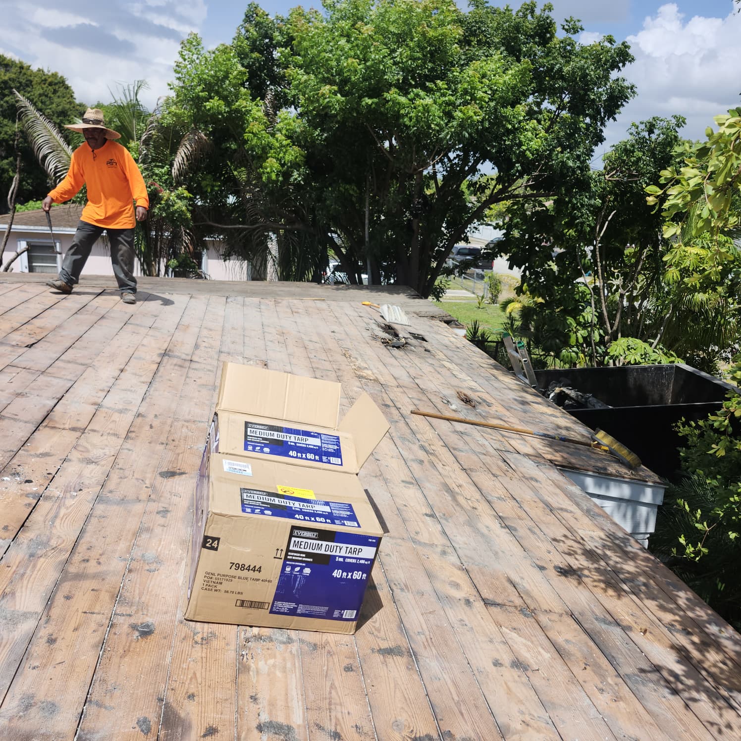 Roofing crew performing documented repairs on a Miami building