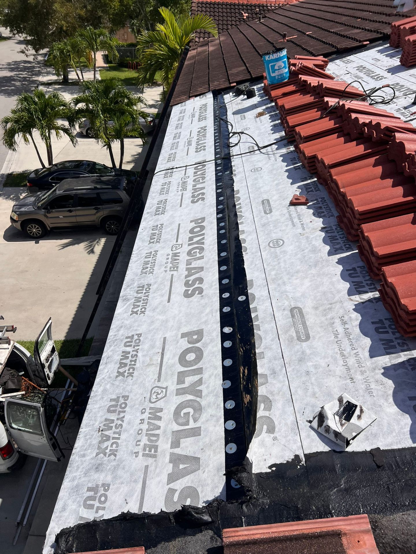 Gutter and roof edge detail protecting a completed Miami roof repair