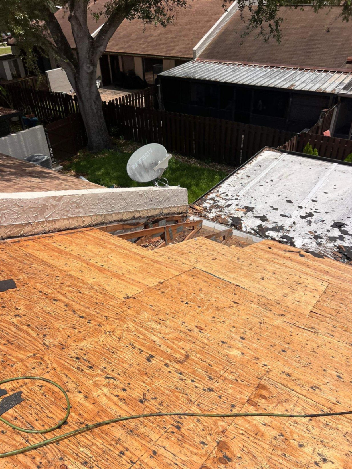 Roofing technician performing roof repair on a Miami home
