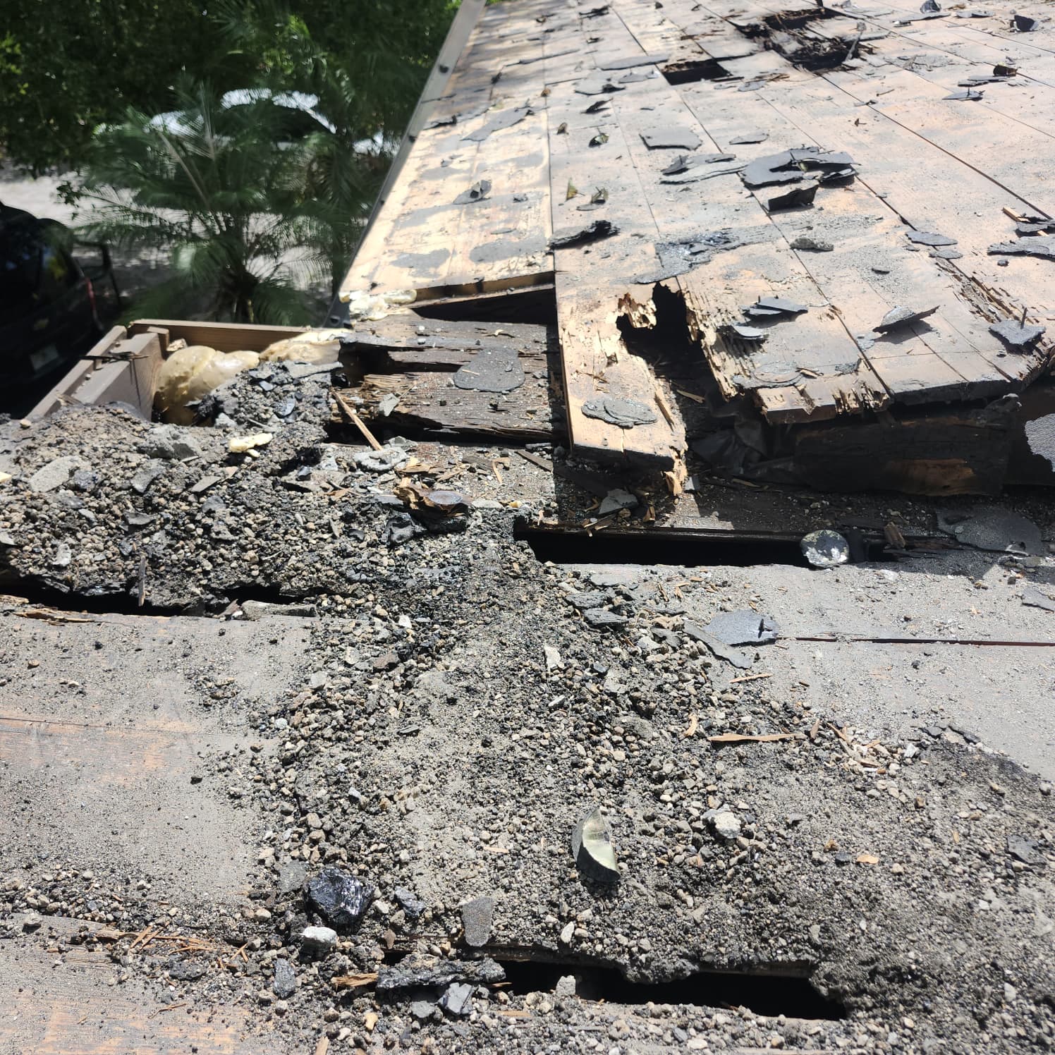 Storm-damaged roof being assessed by a local roofing contractor in Miami-Dade